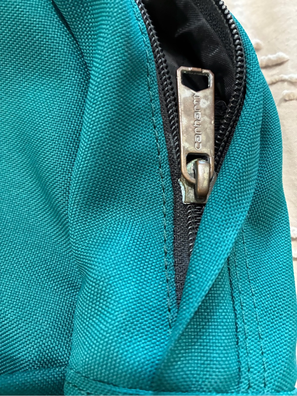 Carhartt teal Mini Backpack front zippered pocket. - Picture 6 of 6